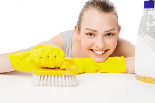 Local cleaner making beds and refreshing a serviced apartment in Stjohnswood