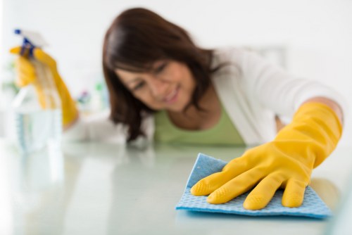 Professional cleaning of shared workspace floors and surfaces